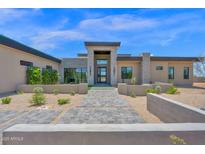 Stunning modern home featuring a meticulously landscaped yard and stylish stone accents at 7261 E Via Dona Rd, Scottsdale, AZ 85266