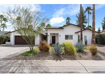 Inviting single-story home featuring low-maintenance desert landscaping and a two-car garage at 7435 E Corrine Rd, Scottsdale, AZ 85260