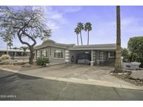 Charming single-story home featuring a covered parking area and desert landscaping in a quiet neighborhood at 8240 E Pueblo Ave, Mesa, AZ 85208