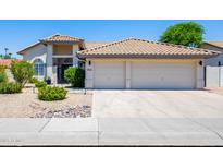 Charming home featuring a spacious two-car garage and well-maintained front yard landscaping at 9032 E Larkspur Dr, Scottsdale, AZ 85260