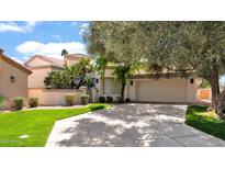 Charming single-Gathering home featuring a well-maintained lawn, mature trees, and a two-car garage at 10421 N 100Th St, Scottsdale, AZ 85258