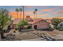 Charming single-story home featuring a tile roof, desert landscaping, and a two-car garage at 10563 E Bella Vista Dr, Scottsdale, AZ 85258