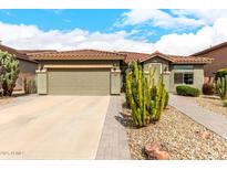 Charming single-story home featuring a tile roof, desert landscaping, and a spacious two-car garage at 11352 E Starkey Ave, Mesa, AZ 85212