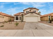 Two-story home with a well-manicured front yard and a two car garage at 12629 W Cambridge Ave, Avondale, AZ 85392