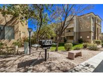 Outdoor community grill and seating area, landscaped with mature trees in a well-maintained community at 18416 N Cave Creek Rd # 2063, Phoenix, AZ 85032