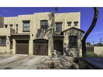 Inviting townhome featuring a two-car garage, covered entryway, and neutral color scheme at 1943 E Hayden Ln # 103, Tempe, AZ 85281