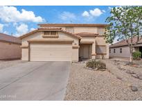 Two-story home with a two car garage, rock landscaping, and tile roof under a partly cloudy blue sky at 1978 E Connemara Dr, San Tan Valley, AZ 85140