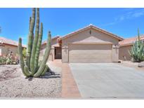 Charming single-story home featuring desert landscaping, a two-car garage, and a welcoming front entrance at 2416 E Santiago Trl, Casa Grande, AZ 85194