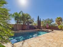 Backyard pool with desert landscaping and lounge chairs, perfect for relaxation at 264 S San Luis Rey Trl, Casa Grande, AZ 85194