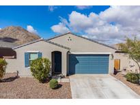 Charming single-story home with blue garage door, shutters, and a low maintenance desert landscape at 34210 N Beeblossom Trl, San Tan Valley, AZ 85144