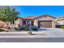 Charming single-story home featuring a stone-accented entry, tile roof, and well-maintained landscaping at 391 N San Ricardo Trl, Casa Grande, AZ 85194