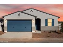 Charming single-story home showcasing a well-manicured front yard and a two-car garage at 41740 W Sonoran Trl, Maricopa, AZ 85138