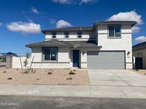 Charming two-story home featuring a gray roof, blue door, and a gray two-car garage at 7208 E Purple Prairie Dr, San Tan Valley, AZ 85143