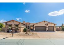 Stunning single-story home featuring a stone facade, three-car garage, and desert landscaping at 10649 E Saddle Blanket Trl, Gold Canyon, AZ 85118