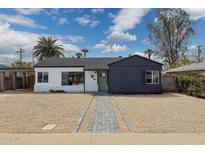 Charming single-story home with a well-manicured front yard and a quaint walkway at 1621 W Mulberry Dr, Phoenix, AZ 85015