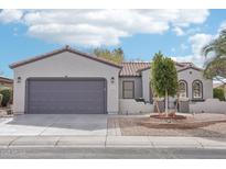 Charming single-story home featuring a two-car garage, desert landscaping, and a neutral color palette at 18327 N Summerbreeze Way, Surprise, AZ 85374