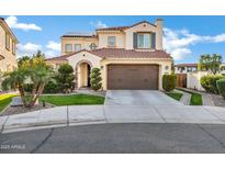 Charming two-story home with a beautiful tile roof, green lawn, and a two car garage at 2395 W Riverside St, Chandler, AZ 85248