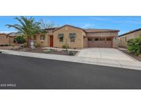 Charming single-Gathering home showcasing a beautifully landscaped front yard and attached two-car garage at 29512 N 128Th Ln, Peoria, AZ 85383