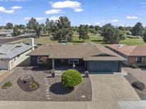 Charming single-story home featuring a well-manicured front yard and an attached two-car garage at 4055 E Catalina Cir, Mesa, AZ 85206