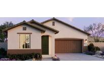 Charming single-story home with a two-car garage, manicured landscaping, and neutral exterior paint at 5640 S 253Rd Ave, Buckeye, AZ 85326