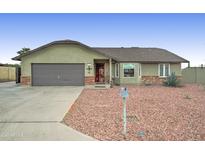 Charming single-story home featuring a two-car garage and low maintenance desert landscaping at 6461 E Jensen St, Mesa, AZ 85205