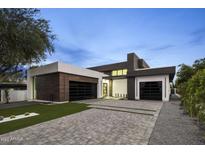 Stunning contemporary home featuring clean lines, a modern design, and a spacious driveway at 7009 E Pasadena Ave, Paradise Valley, AZ 85253