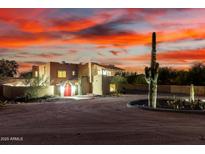 Desert home with unique architecture, cactus landscaping, and a beautiful sunset sky at 706 N Signal Butte Rd, Mesa, AZ 85207