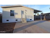 Charming home exterior with a covered porch, fresh concrete and an easy-to-maintain landscaped yard at 7836 E Javelina Ave, Mesa, AZ 85209