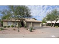 Charming single-story home featuring desert landscaping and a three-car garage at 14648 S 25Th St, Phoenix, AZ 85048