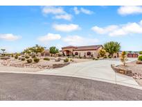 Expansive single-story home featuring a circular driveway and desert landscaping at 3718 N Briere Ct, Buckeye, AZ 85396