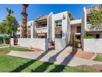 South Scottsdale condominium building with stucco exterior, tiled roof, and desert landscaping at 7350 N Via Paseo Del Sur -- # N104, Scottsdale, AZ 85258