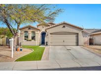 Charming single-story home with manicured lawn and a two-car garage at 10780 W Woodland Ave, Avondale, AZ 85323