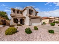 Inviting two-story home featuring a neutral stucco facade, tiled roof, and well-maintained desert landscaping at 11106 E Serafina Ave, Mesa, AZ 85212
