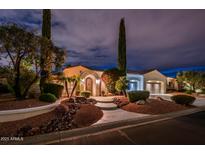 Charming front exterior featuring well-manicured landscaping and inviting entrance at twilight at 13221 W Rincon Dr, Sun City West, AZ 85375