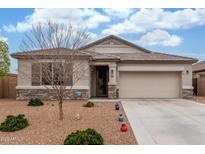 Charming single-story home with a stone accent, desert landscaping, and a two-car garage at 13603 W Remuda Dr, Peoria, AZ 85383