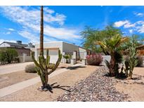 Charming single-story home featuring desert landscaping and white exterior paint at 1510 E Wescott Dr, Phoenix, AZ 85024