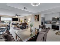 Open-concept dining area with modern table, chairs and connecting living and kitchen area at 16624 E Palisades Blvd # 101, Fountain Hills, AZ 85268