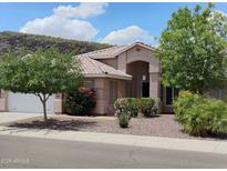 Charming single-story home with desert landscaping, a tile roof, and mature shade trees in a sunny neighborhood at 20630 N 42Nd Ave, Glendale, AZ 85308