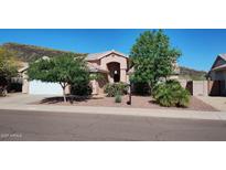 Charming single-story home featuring desert landscaping and a two-car garage at 20630 N 42Nd Ave, Glendale, AZ 85308
