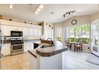 Beautiful kitchen features white cabinets, stainless steel appliances, and a breakfast nook at 20630 N 42Nd Ave, Glendale, AZ 85308