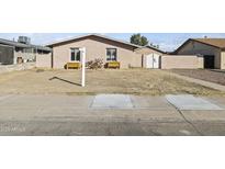 Charming single-story home featuring xeriscaping, flower beds and classic window shutters at 2348 W Laurel Ln, Phoenix, AZ 85029