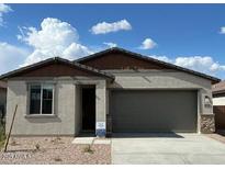 Charming single-story home featuring a neutral color palette, a two-car garage, and low maintenance landscaping at 25156 W Wayland Dr, Buckeye, AZ 85326