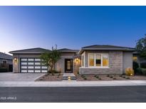 Charming single-story home with a modern design, desert landscaping, and a convenient two-car garage at 3244 E Daley Ln, Phoenix, AZ 85050