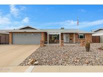 Charming single-story brick home featuring a well-maintained front yard with decorative rock and a two-car garage at 4432 E Carmel Ave, Mesa, AZ 85206