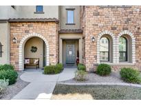 Charming townhome exterior featuring stone accents, arched entry, and a cozy bench at 4777 S Fulton Ranch Blvd # 2101, Chandler, AZ 85248