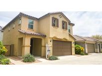 Charming two-story home with a tile roof, two-car garage and covered entry way at 6853 E Posada Cir, Mesa, AZ 85212