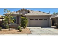 Charming single-story home featuring a well-manicured front yard and an attached two-car garage at 7133 N 123Rd Dr, Glendale, AZ 85307