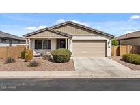 Charming single-story home with a well-maintained front yard and two-car garage at 730 W Wind Cave Dr, San Tan Valley, AZ 85140