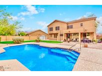 Inviting backyard pool with a view of the home's exterior and covered patio seating area at 9758 E Monterey Ave, Mesa, AZ 85209