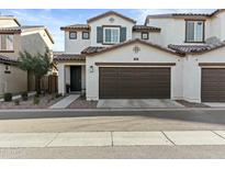 Inviting two-story home featuring a two-car garage and manicured front yard landscaping at 1255 N Arizona Ave # 1043, Chandler, AZ 85225